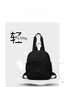 Lightweight black commuter backpack weighing only 0.55kg shown with floating feathers