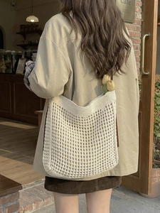 Chic beige woven crochet tote bag with brown straps for summer beach or casual streetwear