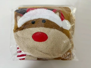 Detail of Christmas reindeer toilet seat cover set folded in plastic packaging