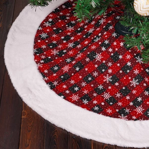 Detail of red and black buffalo plaid Christmas tree skirt with white snowflake patterns