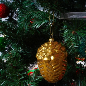 Golden pinecone Christmas ornament with metallic finish on a decorated holiday tree