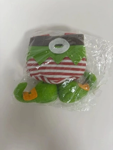 Folded Christmas elf costume gift bag made of red and green felt in clear packaging