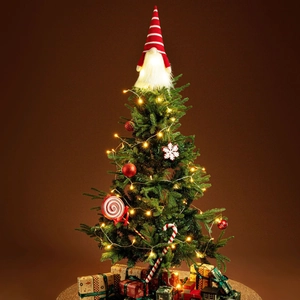 Close-up of a festive gnome tree topper with a glowing LED beard and red striped knit hat
