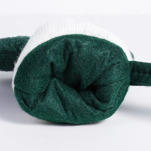 Detailed view of green plush velvet and white knit texture on a festive Christmas sock