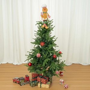 Festive gingerbread man tree topper on a decorated Christmas tree with gift boxes
