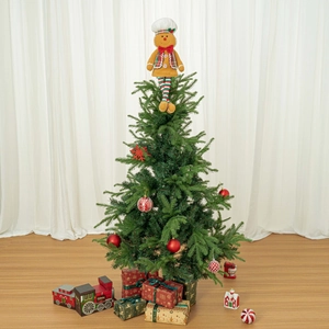 Detail of gingerbread man chef tree topper with plush texture and festive accessories