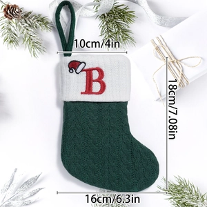 Detail of green cable knit Christmas stocking with letter B and dimensions labels