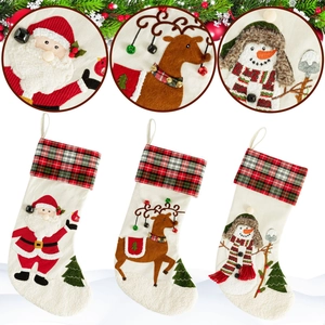 Three Christmas stockings with plaid cuffs and Santa, reindeer, snowman appliques