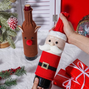 Knitted Santa and reindeer wine bottle covers in a festive holiday home setting