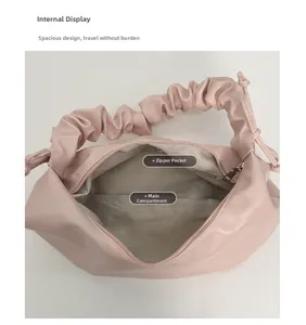 Interior view of pleated pink tote showing main compartment and zipper pocket