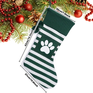 Detail view of knitted striped Christmas pet stocking with paw print and dimensions