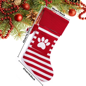 Detailed view of red and white striped Christmas stocking with paw print and dimensions