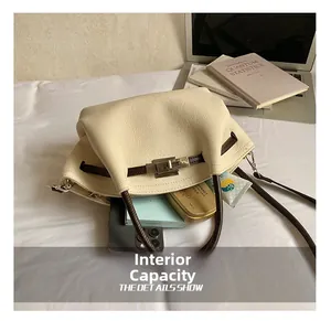 Detail view of the cream leather tote bag showcasing its spacious internal capacity