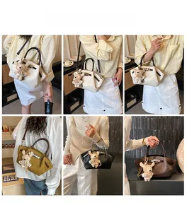Close-up of minimalist tote bag with metal twist lock and cute bear charm in four colors