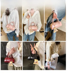 Chic patent leather boston bags in four colors shown with plush bear charms and straps