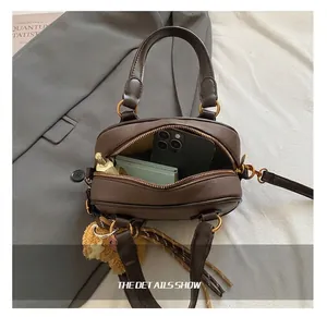 Internal view of brown pebble leather small square bag showing daily storage capacity