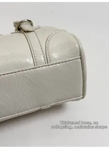 Detail of reinforced bag bottom showing stable support and silver hardware hardware