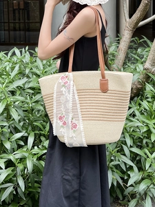 Large striped straw tote bag with brown faux leather straps and lace floral embroidery ribbon