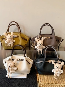 Vintage top handle bag with knitted bear charm in four colors and metallic lock detail