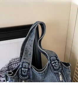 Close-up of durable denim shoulder strap with leather reinforcement and rivets