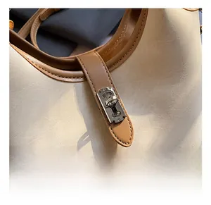 Detailed close-up of the vintage silver metal swivel lock and beige leather texture