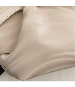 Detail of the soft beige faux leather fabric with natural textured folds and creases
