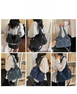 Detail view of denim crossbody bag with multiple zippers and adjustable straps