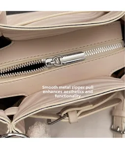 Detailed close-up of smooth silver metal zipper and finish on pink shoulder bag