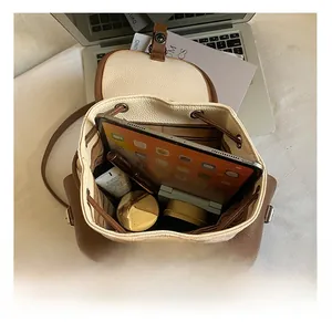 Close-up of spacious interior in vintage backpack showing tablet and daily essentials