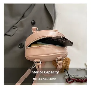 Internal capacity of pink mini bowling bag with lychee texture and smartphone reference