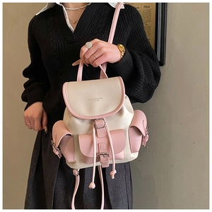Detail of vintage drawstring backpack with contrast color stitching and pebble leather texture