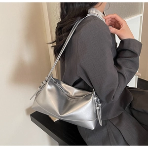 Detail of silver metallic shoulder bag with smooth zipper and adjustable slim strap