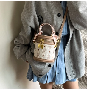 Détail d'un sac seau blanc crème avec motifs ours et poignée en foulard fleuri