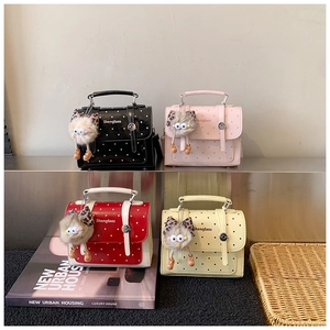 Polka dot crossbody bags in black, pink, red, and beige with cute cat plush charms
