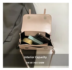 Detailed interior capacity view of a pink PU crossbody bag showing space for phone and makeup