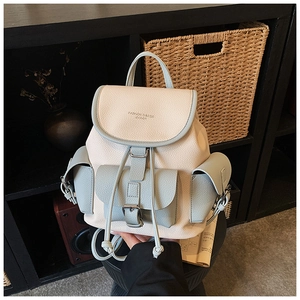 Detail of vintage drawstring backpack with lychee texture leather in cream and light blue