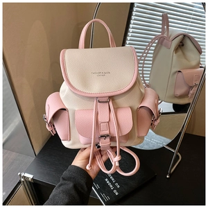 Detail of lychee pattern leather backpack with drawstring closure and pink contrast pockets