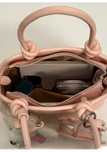 Internal view of pink shell bag showing space for phone, lipstick and cosmetics