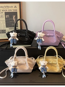 Retro pleated crossbody bags in four colors with teddy bear charms on display