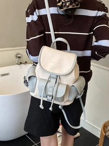 Retro contrast color backpack with drawstring closure and buckle pockets on model