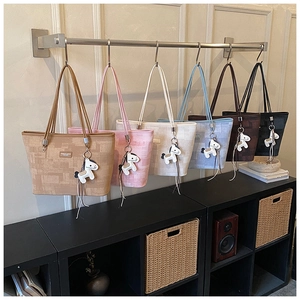 Collection of textured bucket bags in six colors with decorative white horse charms
