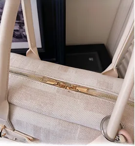 Detail of high-quality smooth dual metal zippers on a textured fabric tote handbag