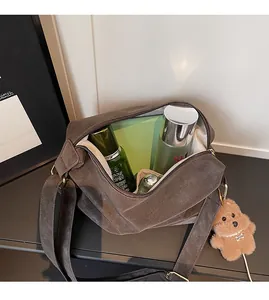 Interior view of brown matte crossbody bag showing large capacity with plush bear charm