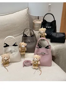 Detail of lychee pattern bucket bags in multiple colors with bear charms and inner pouches