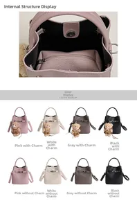 Detail of faux leather bucket bag showing inner zipper compartment and turn-lock closure