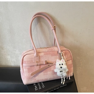 Detail of pink plaid denim tote bag featuring a cute white puppy plush keychain