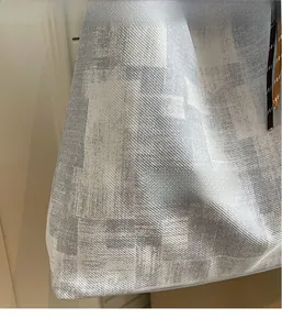 Detail of crossbody bag with twill fabric texture and decorative woven drawstring