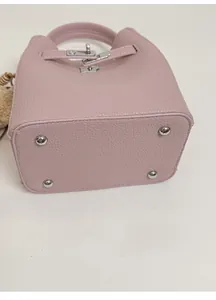 Detailed view of the bottom metal rivets on a lavender leather bucket bag for durability