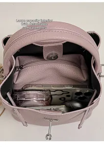 Pink lychee grain leather bucket bag featuring spacious interior with a detachable pouch