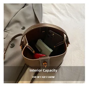 Interior view showing large capacity for essentials in brown pebble grain bucket bag